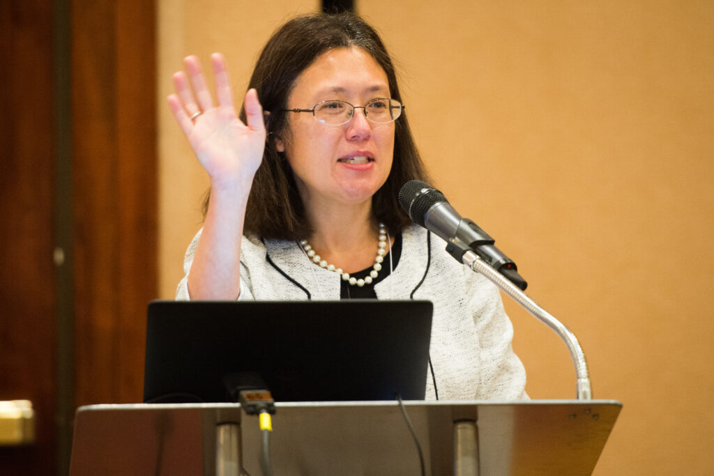 Dr. Wendy Chung, Director of Clinical Research at SFARI at the Simons Foundation, gives the Thursday morning keynote address at a podium.