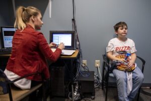 a female researcher monitors a childs pulse